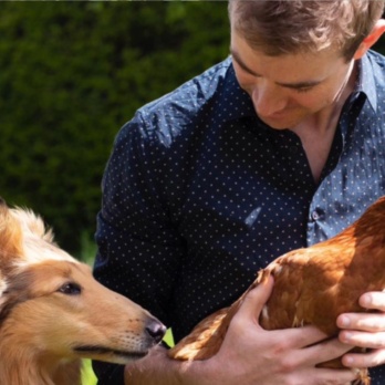 Fiachra Garvey with a dog and a chicken