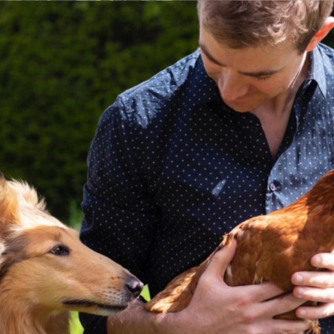 Fiachra Garvey with a dog and a chicken